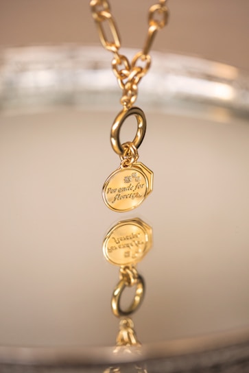 Elegant gold-plated necklace with a personalized laser-engraved pendant on a beige background