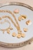 a silver tray topped with lots of gold jewelry