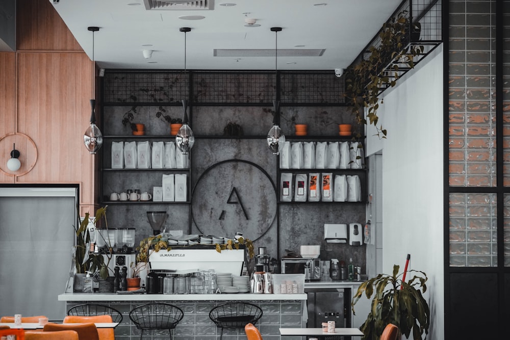 a restaurant with orange chairs and a large clock on the wall