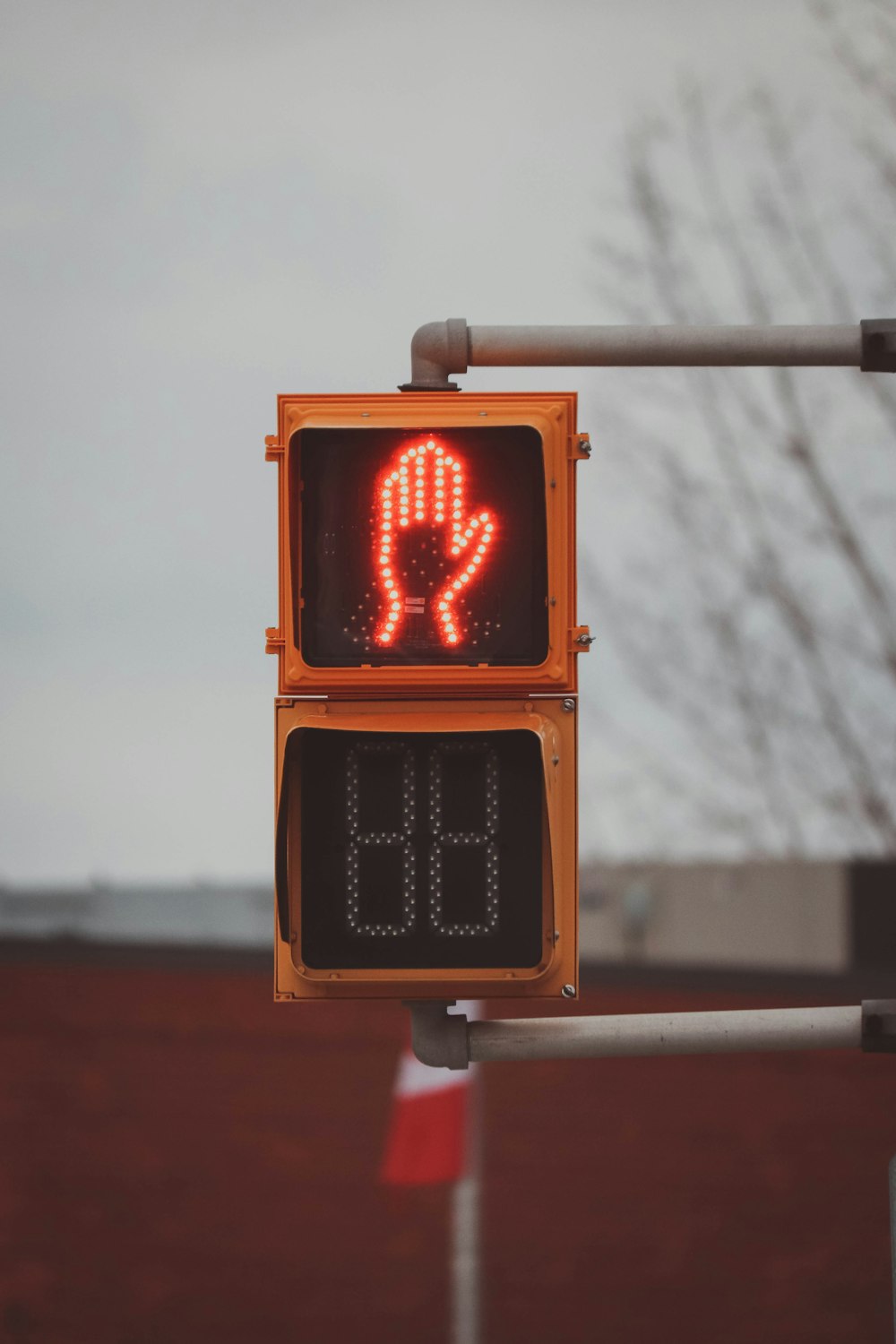 a traffic light that has a red hand on it