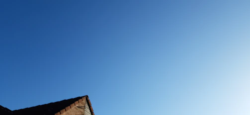 Close-up of a freshly installed dry ridge on a sloped roof under bright daylight.