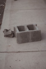 a concrete block sitting on the side of a sidewalk