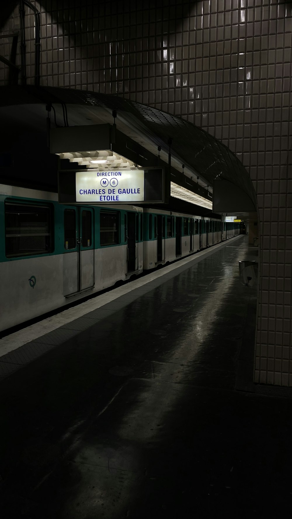 a subway train parked in a station at night