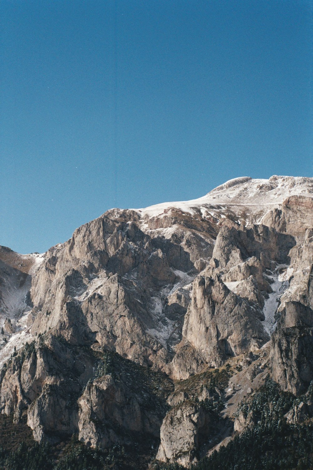 a mountain with a snow covered peak in the distance