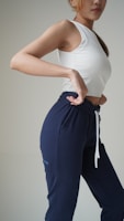 a woman in a white top and blue pants