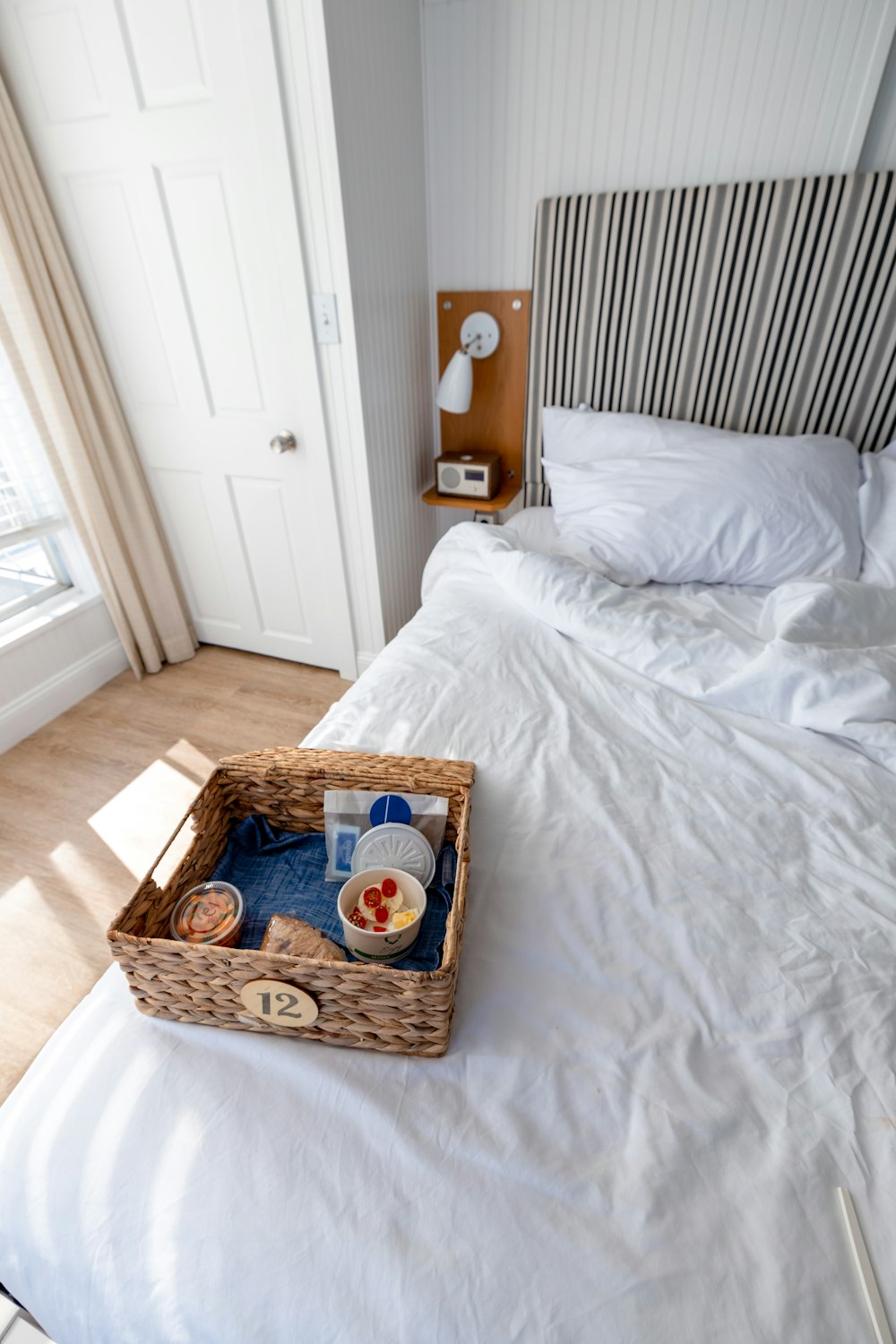 a bed with a basket of food on top of it