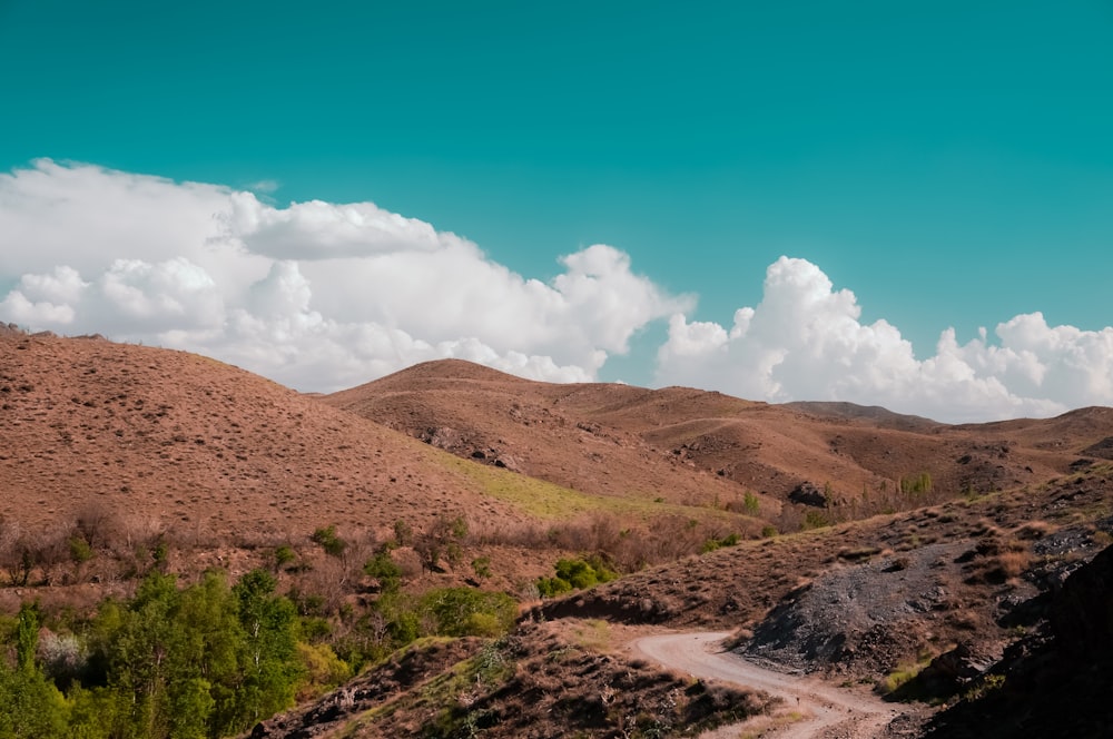 a dirt road in the middle of a mountain range