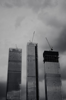 a couple of tall buildings under a cloudy sky