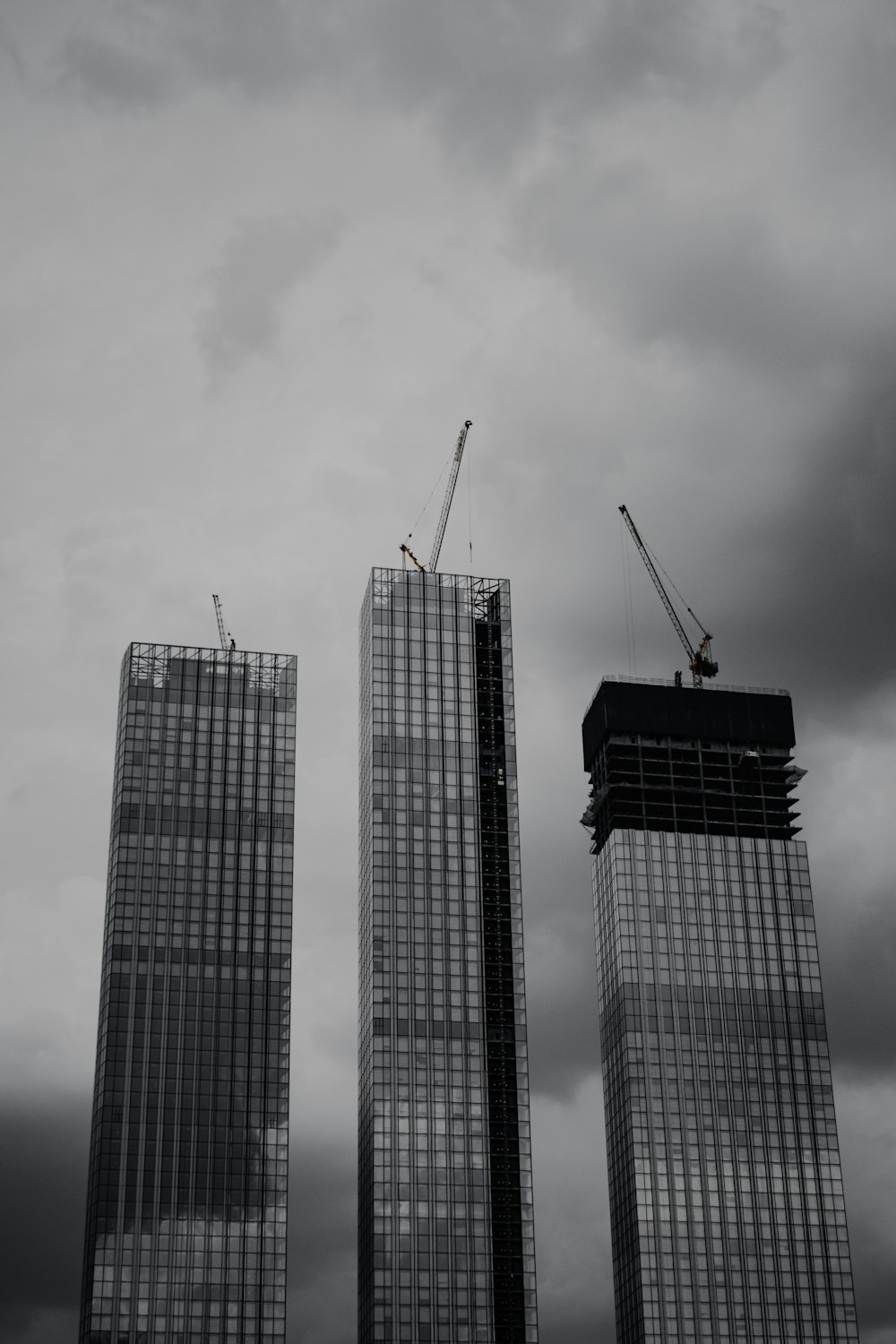 a couple of tall buildings under a cloudy sky