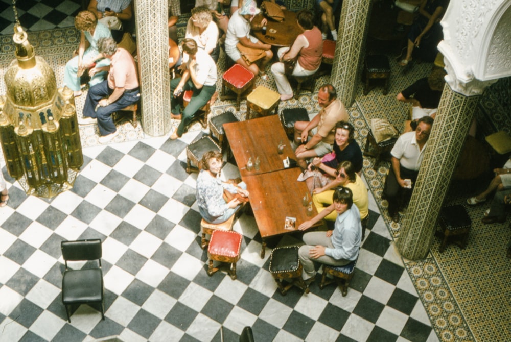 a group of people sitting around a table in a room