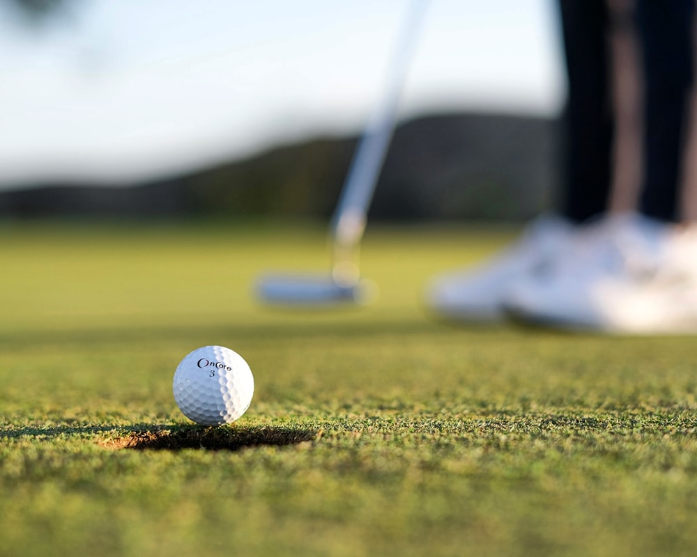 a golf ball sitting on the green of a golf course