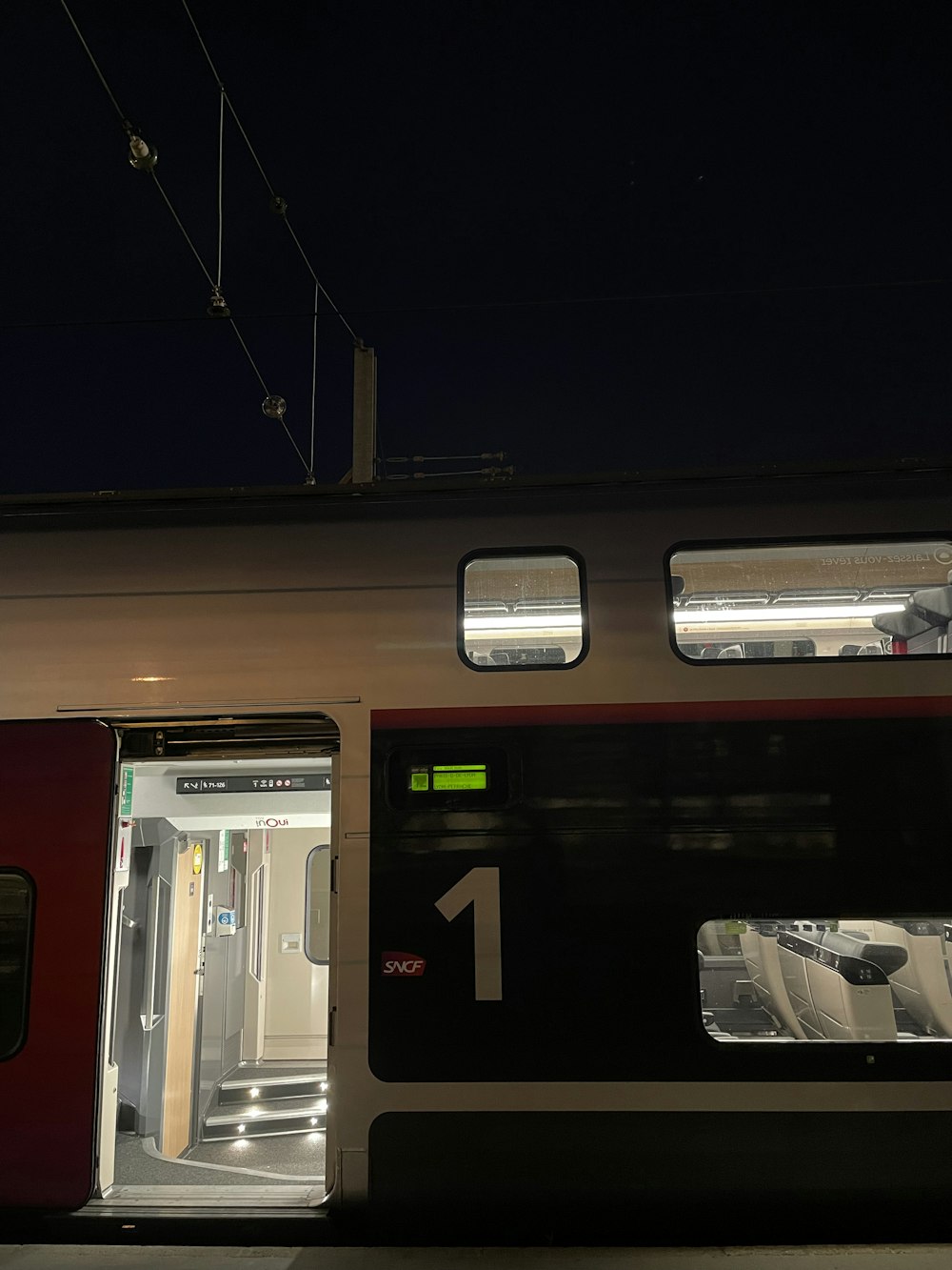 a train with its doors open at night