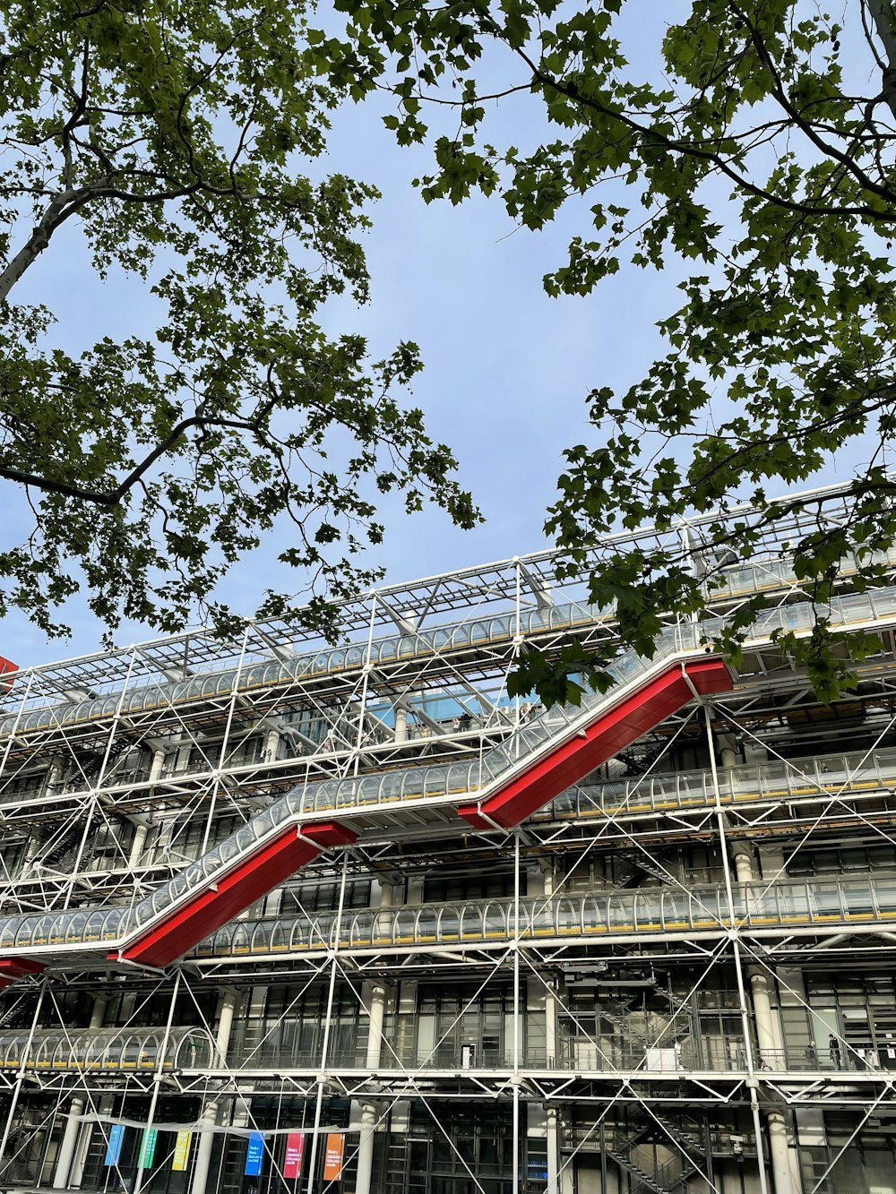 a large building with a red staircase going up it's side