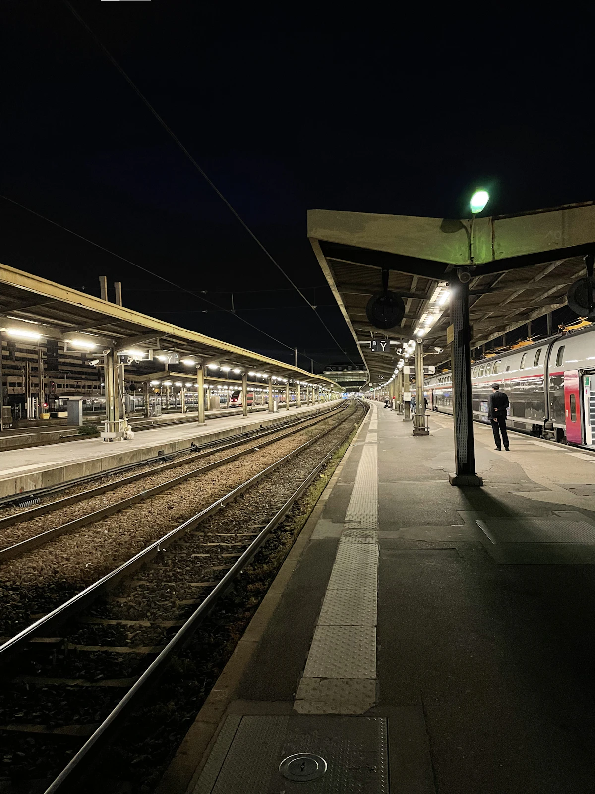 A French high-speed train waiting at a station platform