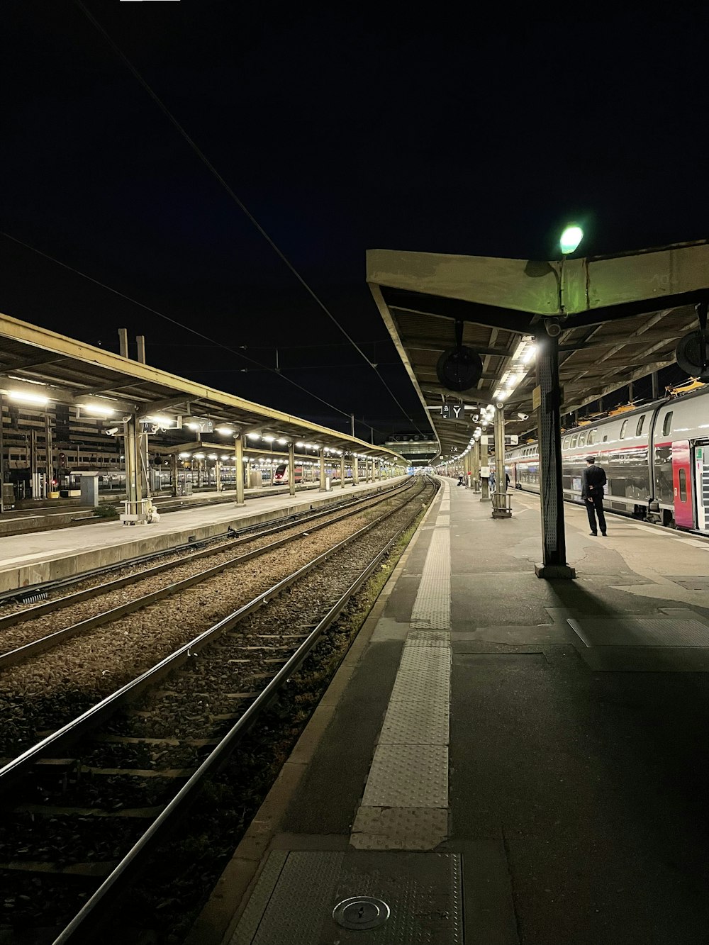 a train pulling into a train station at night