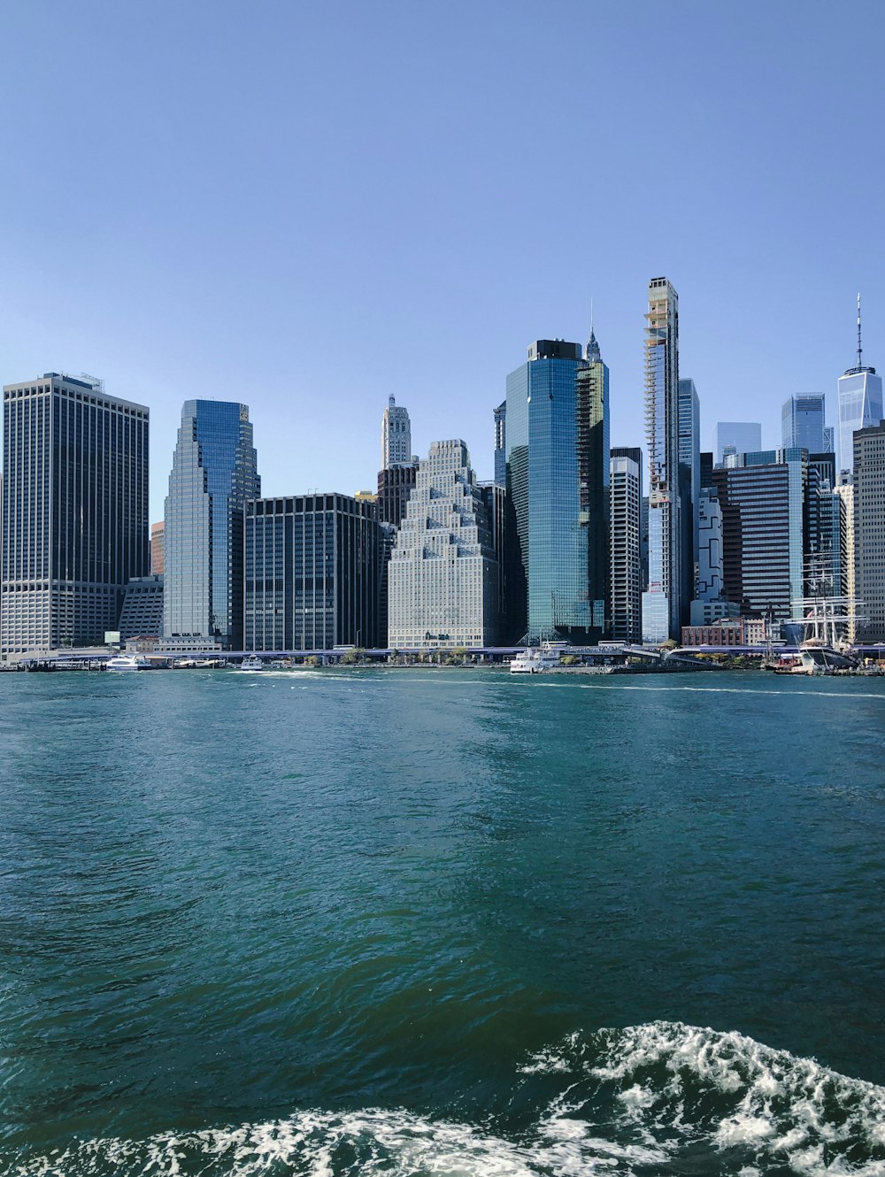 a large body of water with a city in the background