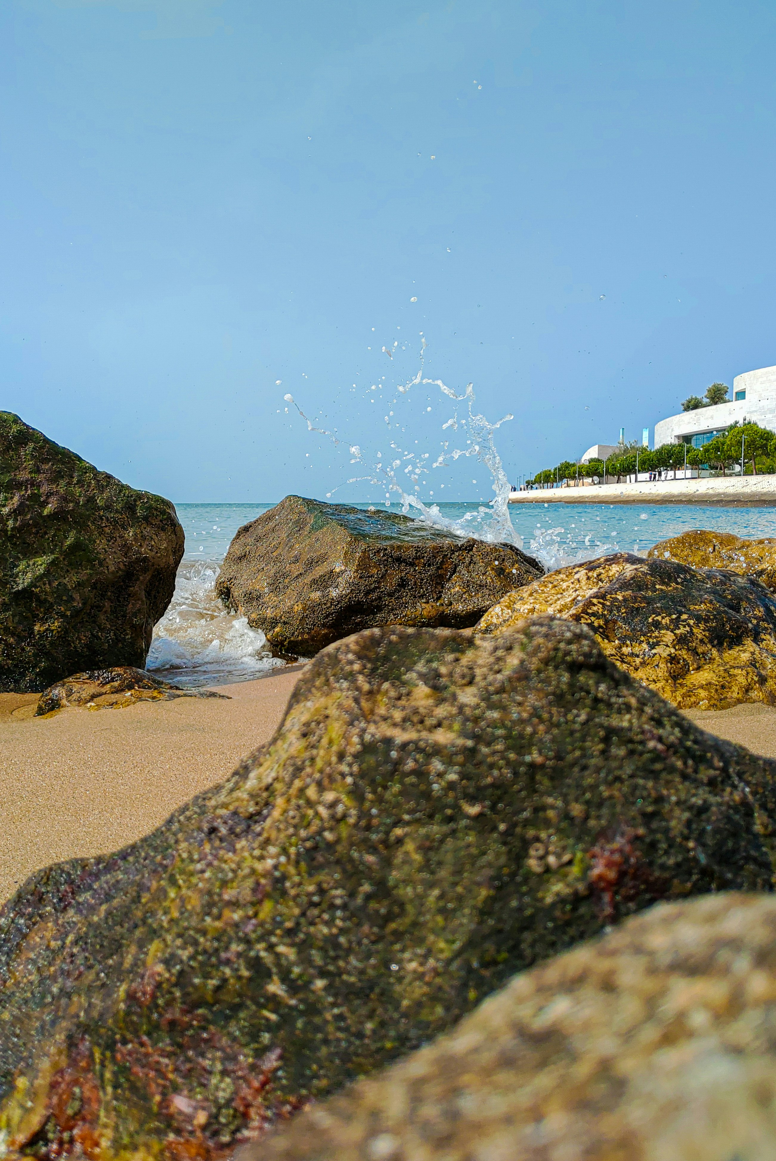 a large rock sitting on top of a sandy beach