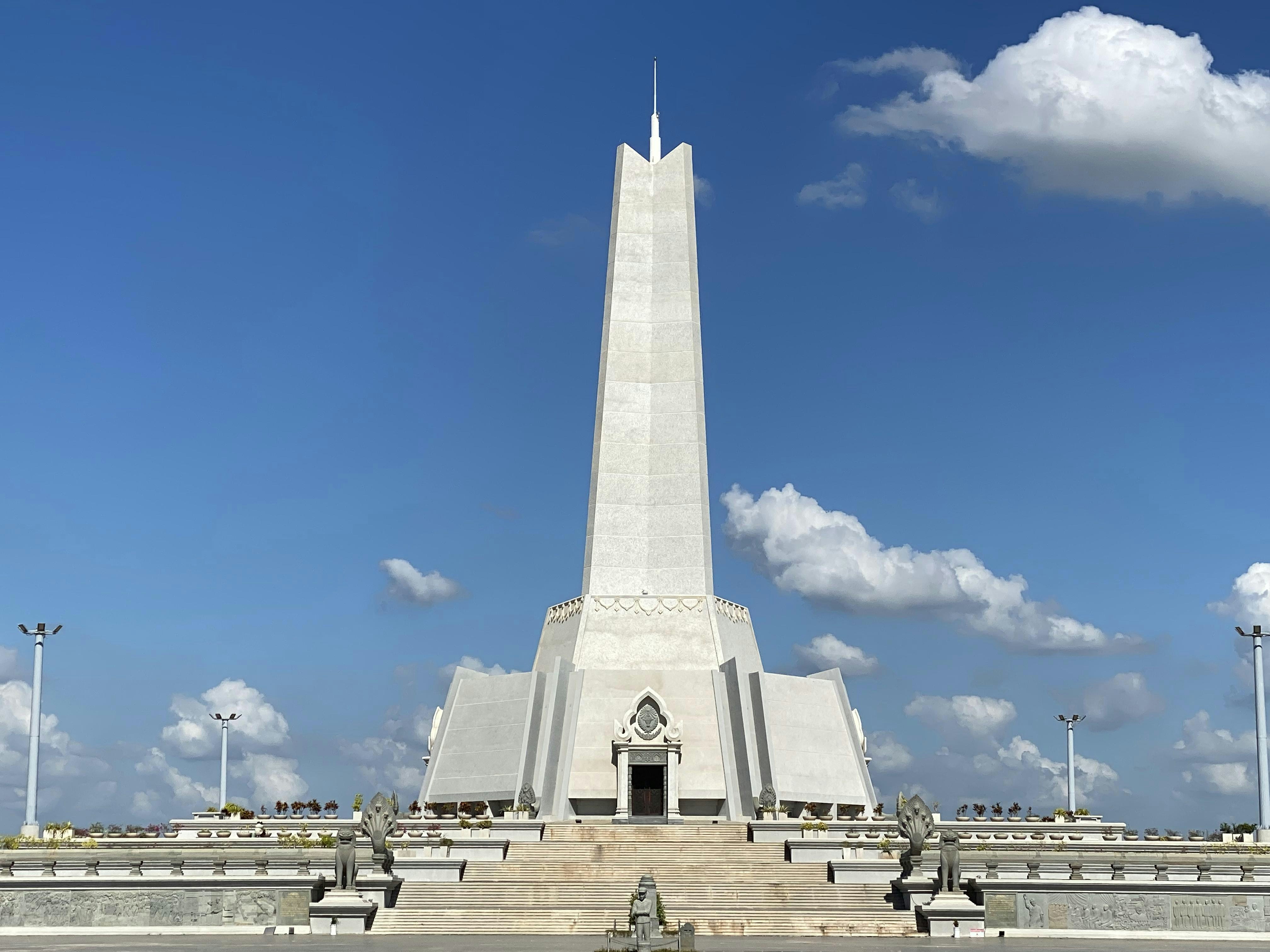 a tall monument with a clock on the top of it