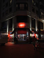 Night view of the storefront illuminated with elegant signage.