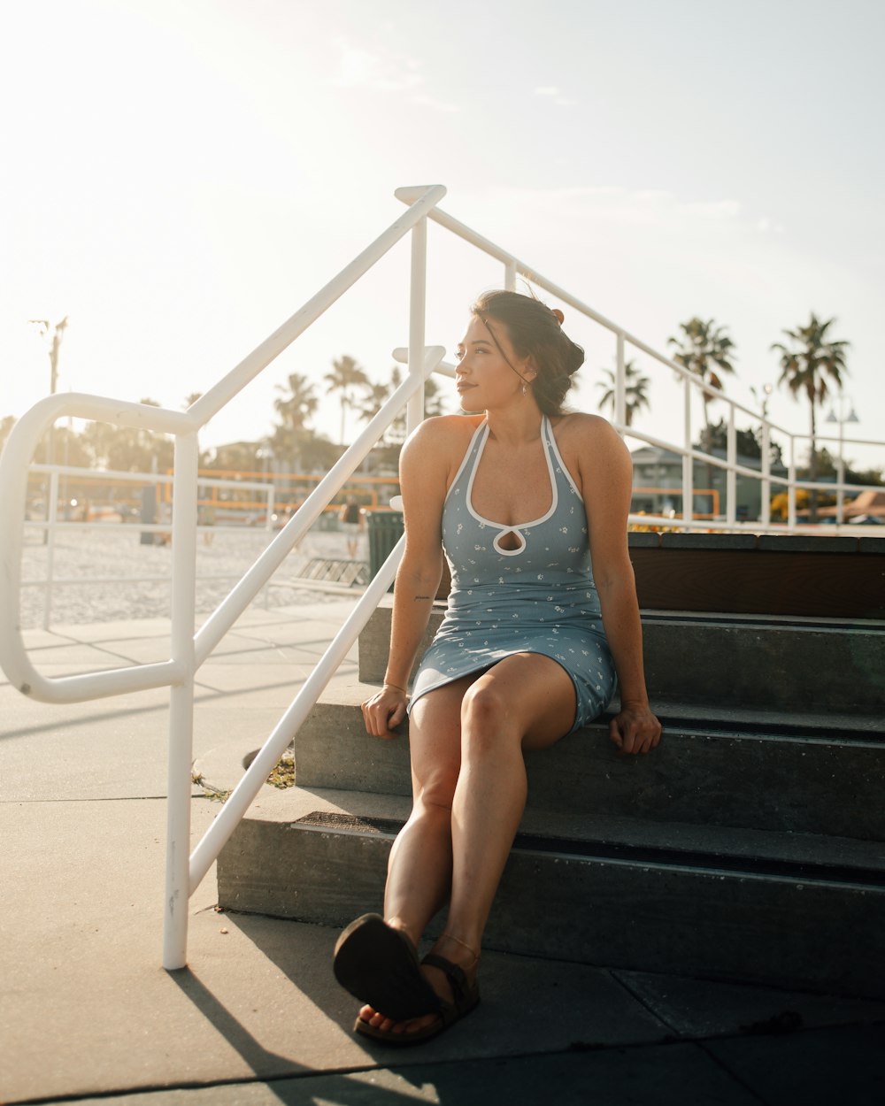 a woman sitting on a set of stairs