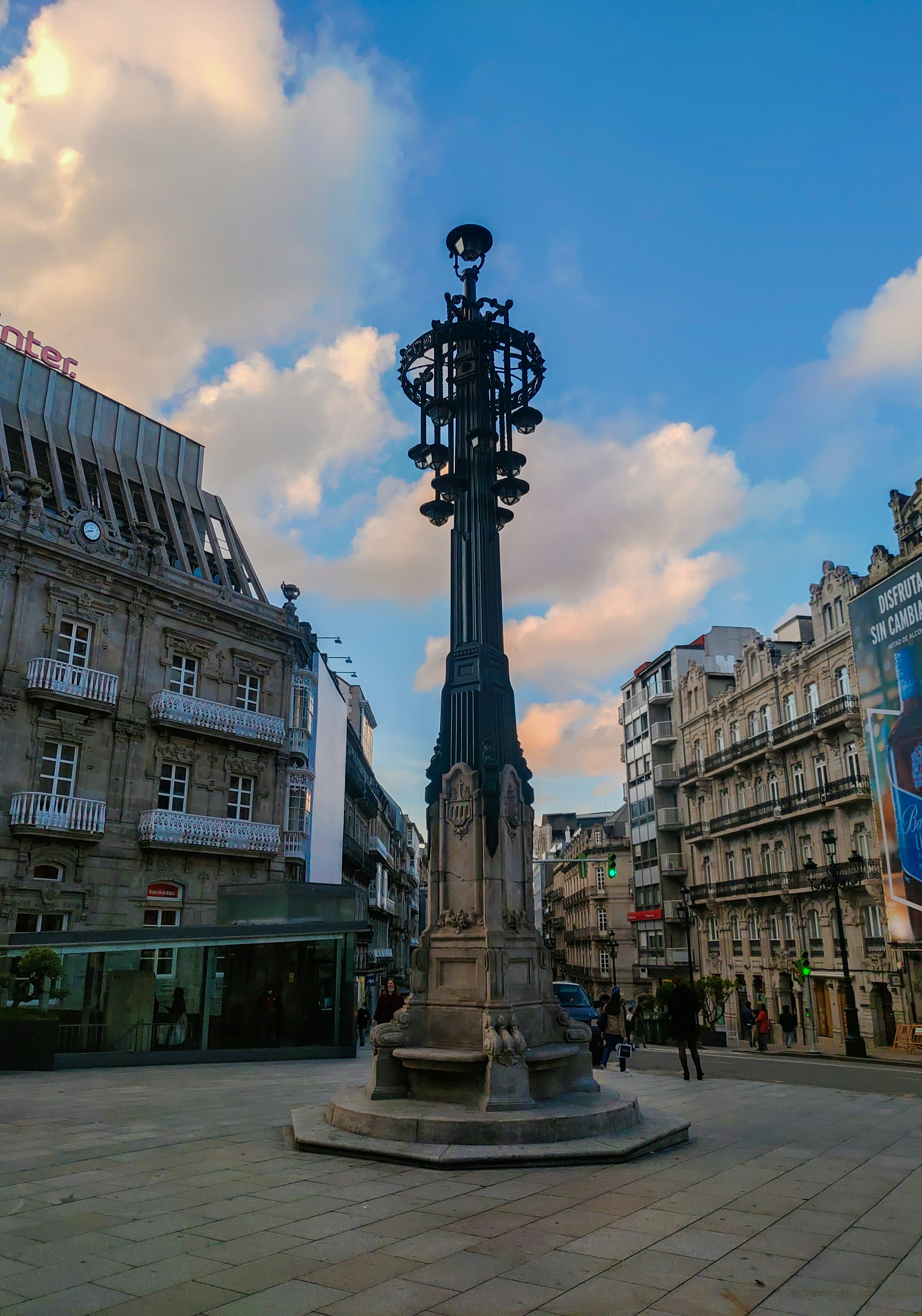a clock tower in the middle of a city square