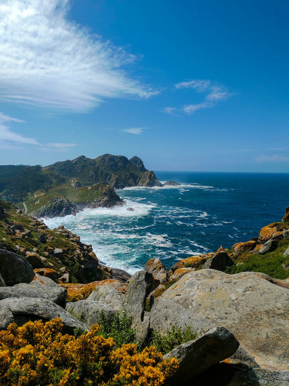 a view of the ocean from the top of a hill