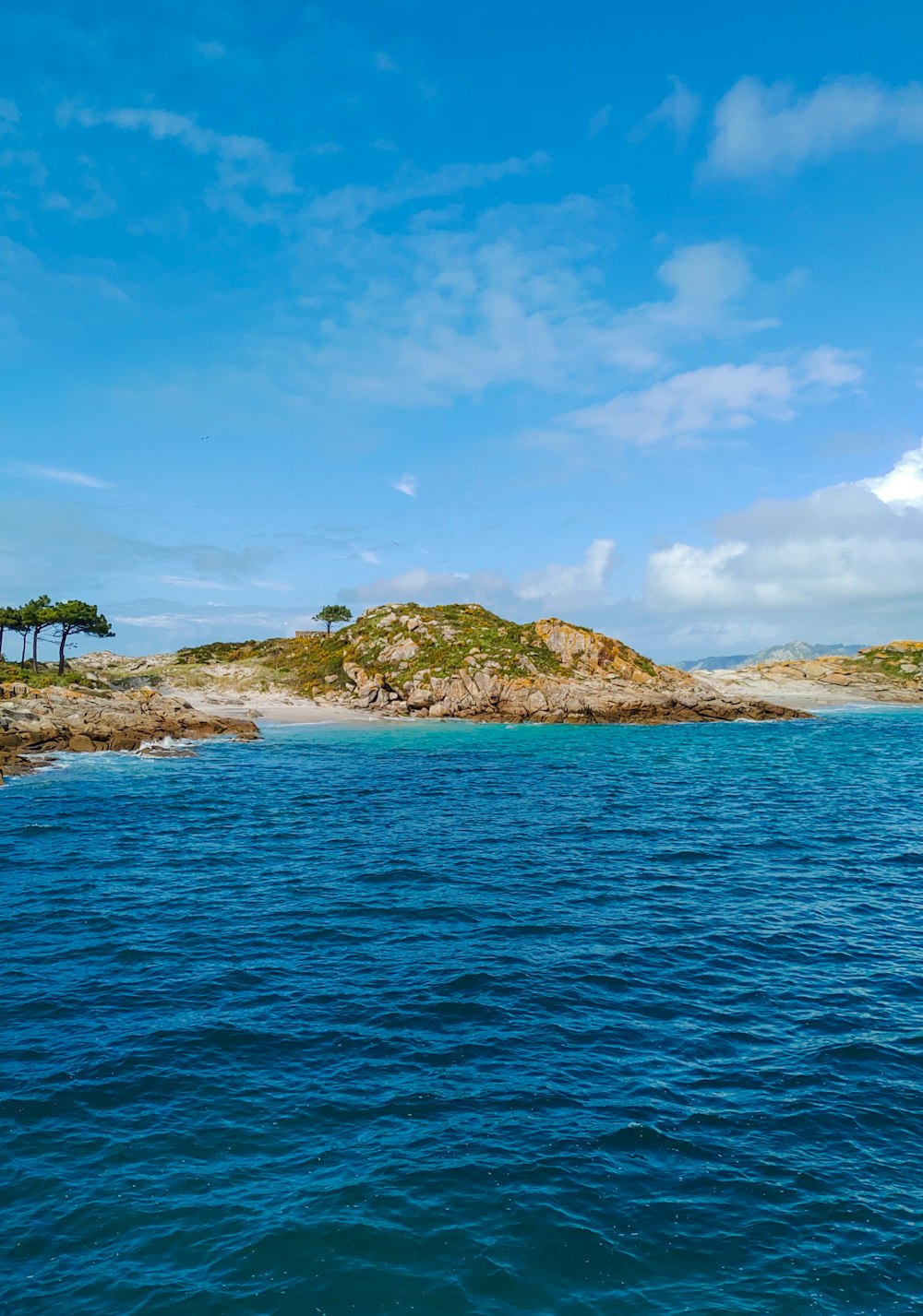 a body of water with a small island in the background