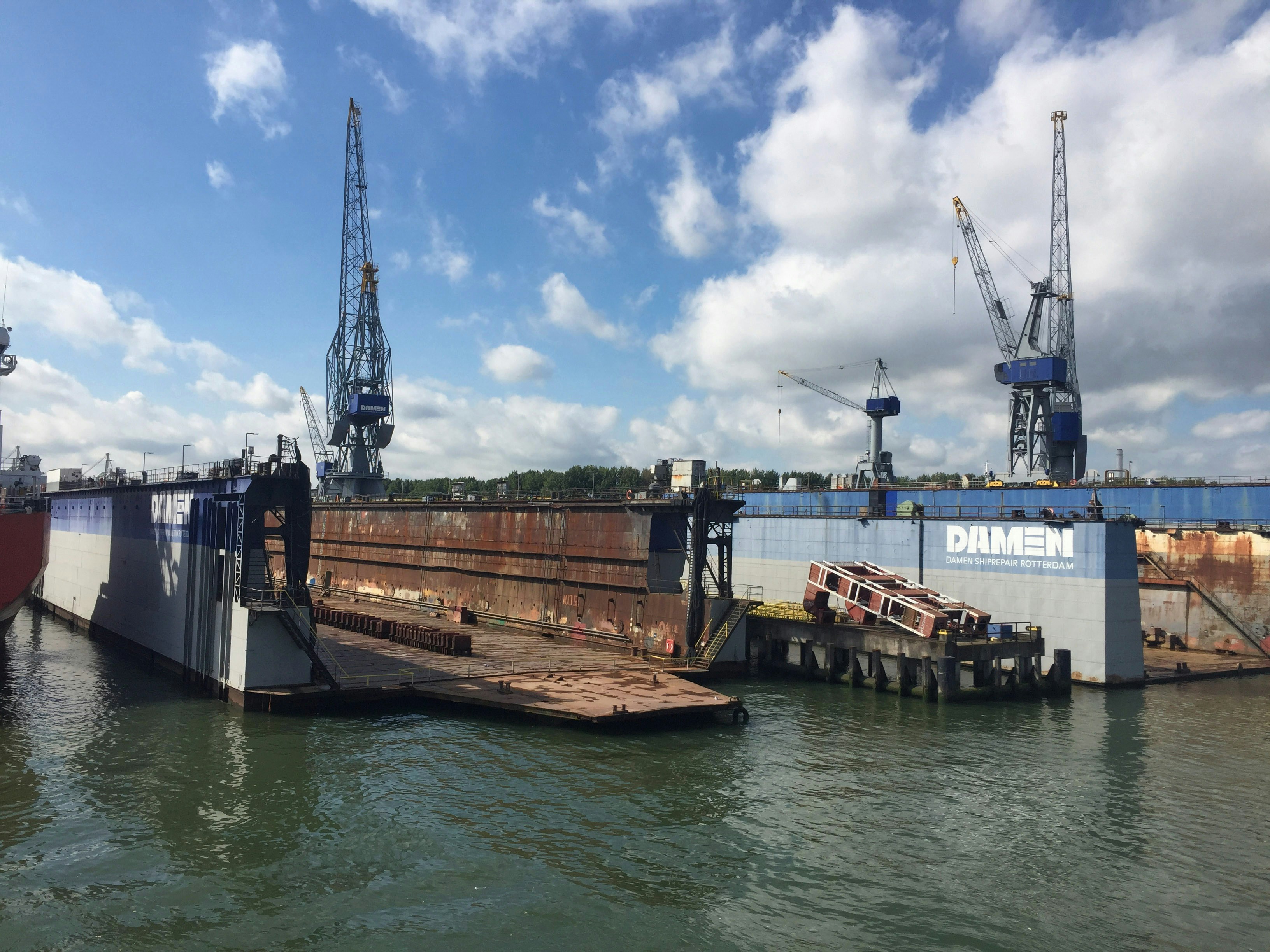 barge with a pile driver installing a steel piling for a dock - boat dock anchor system