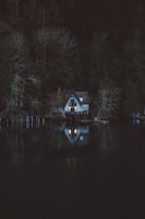 A cozy cabin with flickering candlelight and shadowy figures hinting at a gentle horror tale.