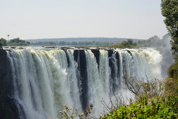 A large waterfall with water pouring out of it — Victoria Falls, Zimbabwe