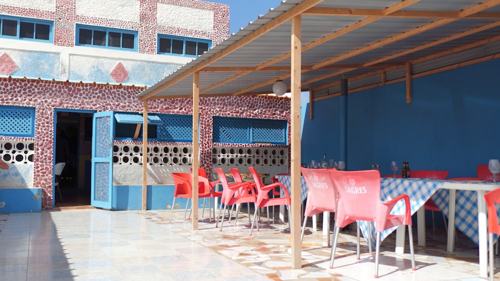 a restaurant with blue walls and red chairs