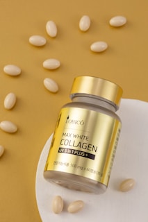 a jar of collagen on a plate with almonds