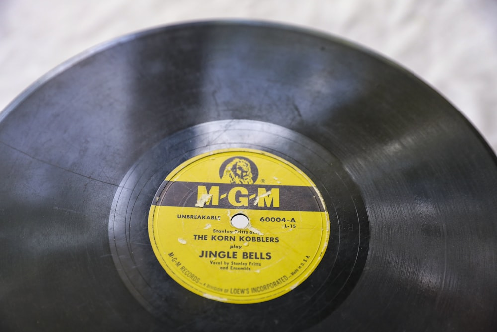 a black record with a yellow label on it