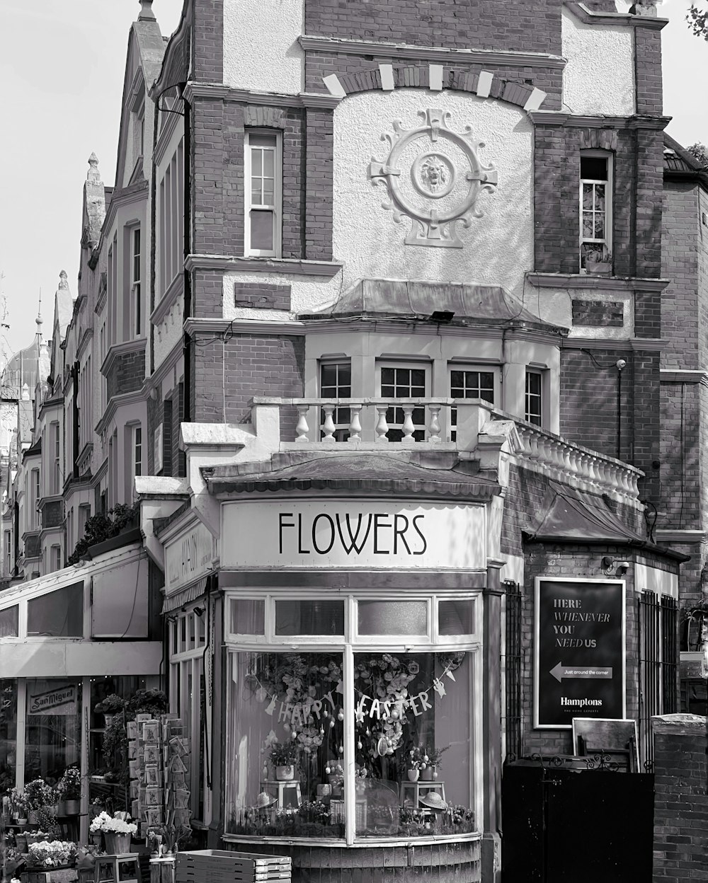 a black and white photo of a flower shop