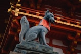 a statue of a dog wearing a red shirt