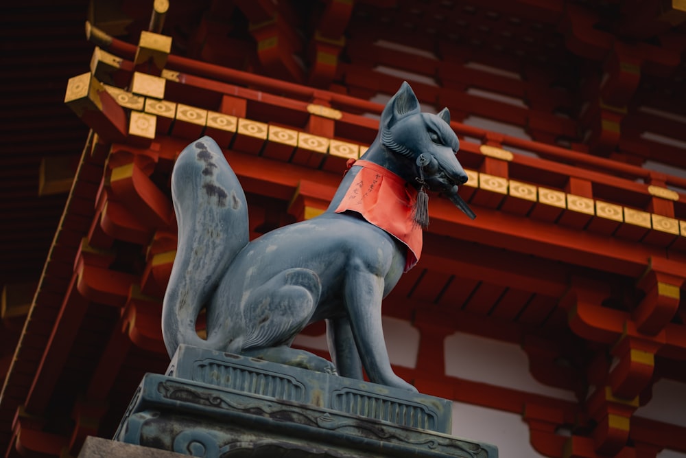 a statue of a dog wearing a red shirt