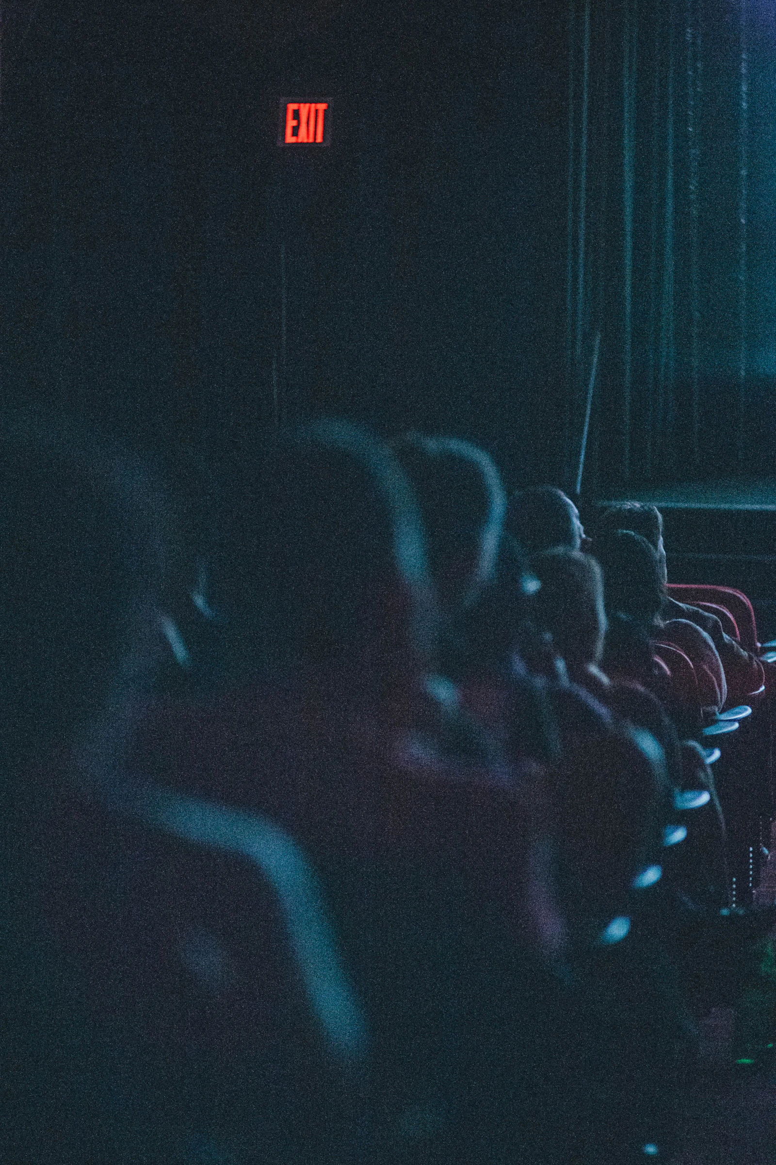 An audience seated in a dark auditorium