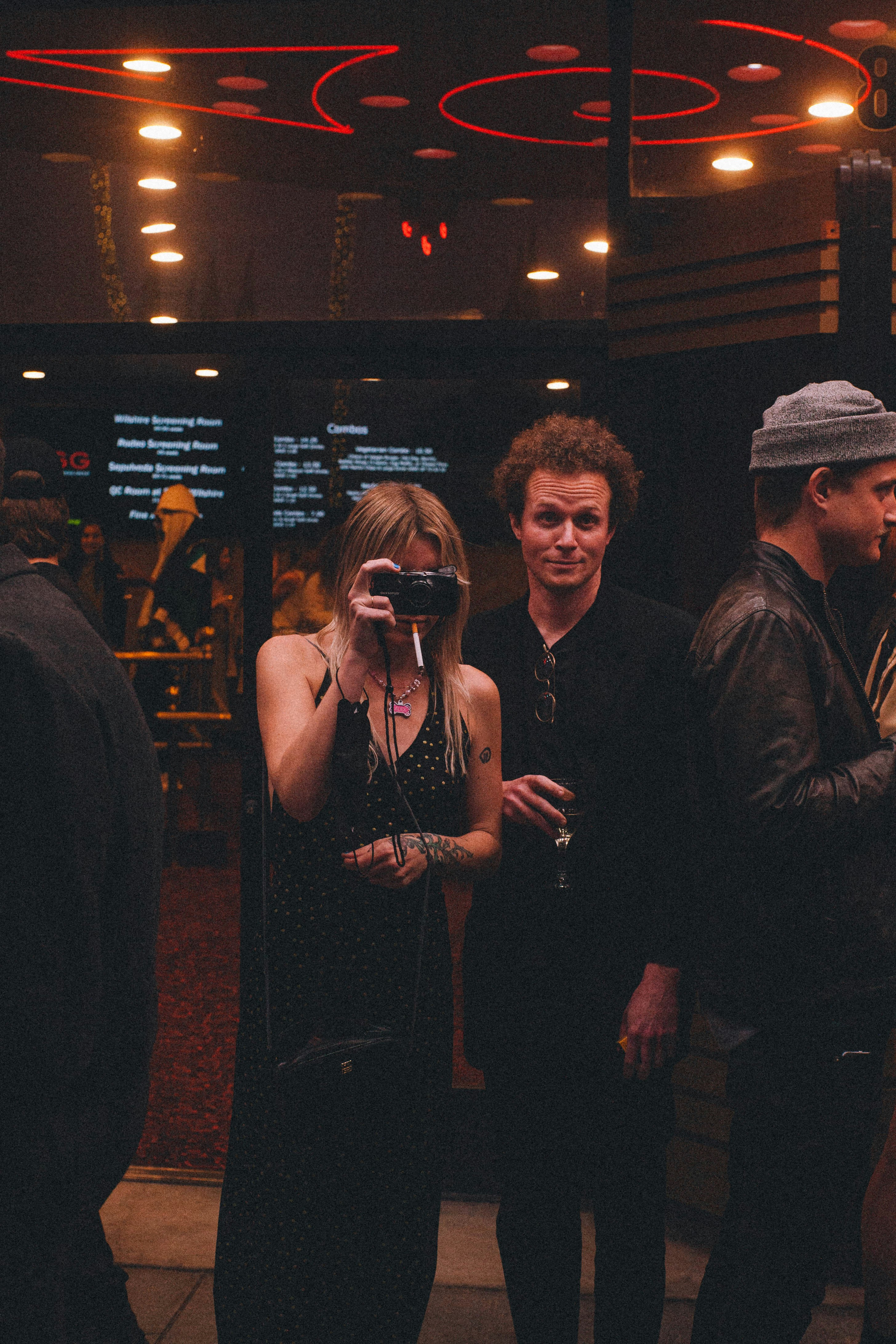 a group of people standing in front of a crowd posing for the camera