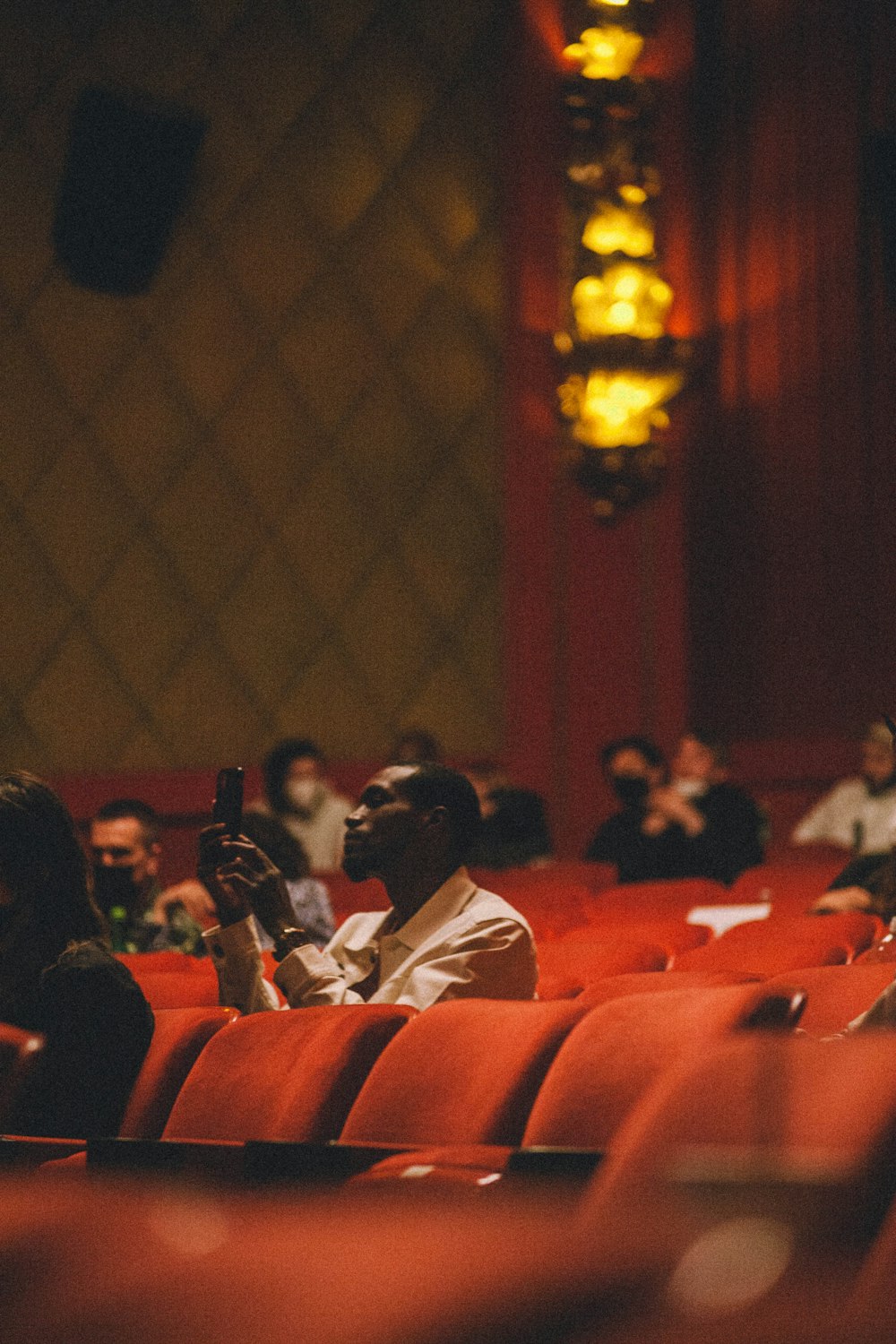 a group of people sitting in a theater