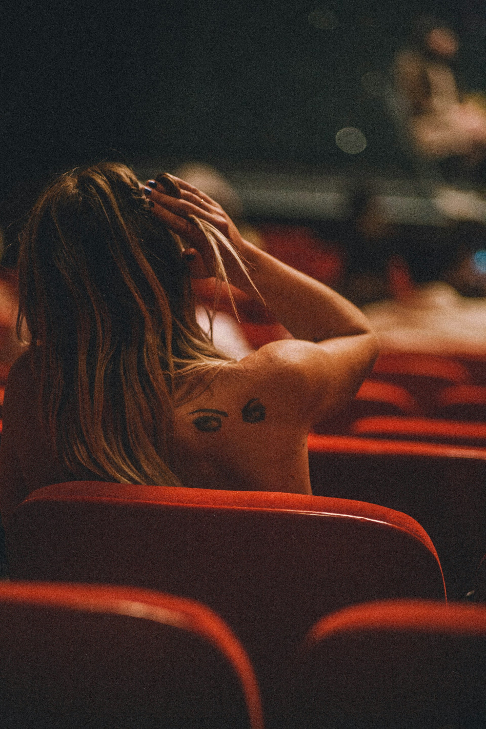 a woman sitting in a dark room