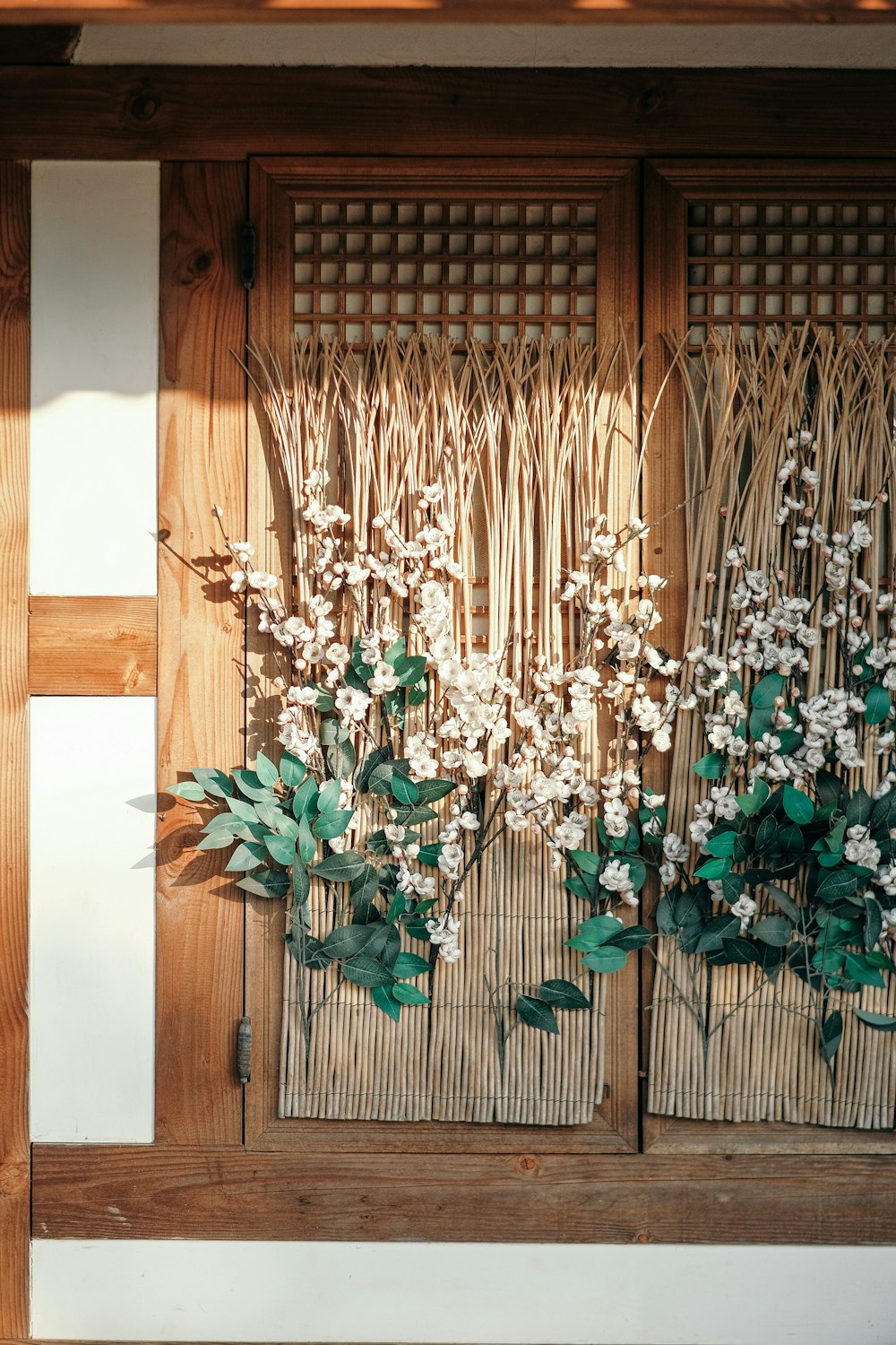 a close up of a wooden door with flowers on it
