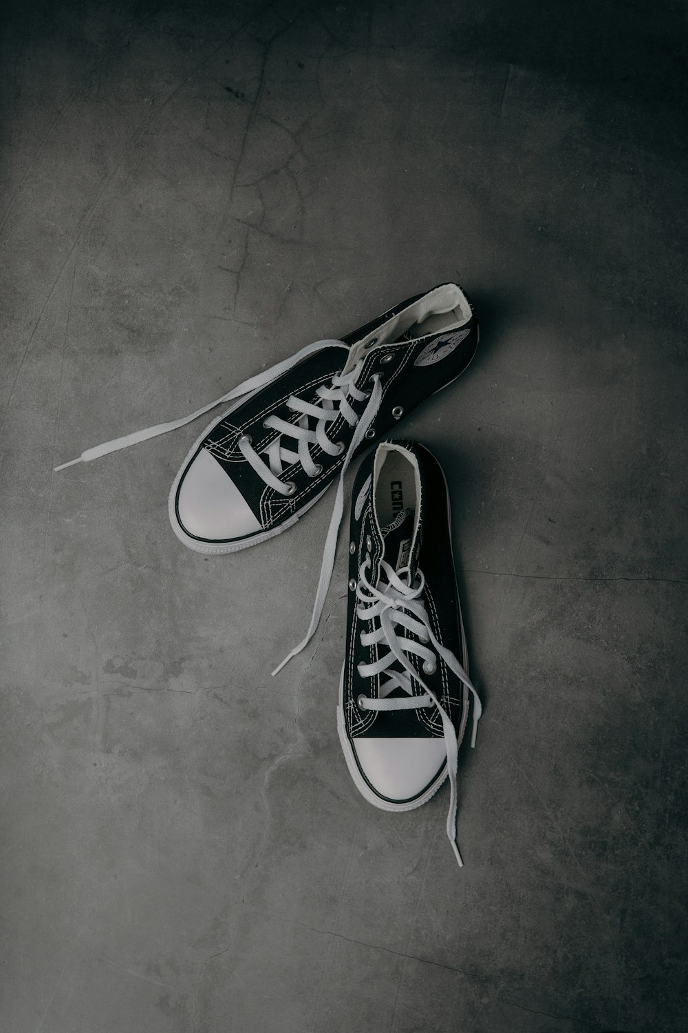 a pair of black and white converse sneakers