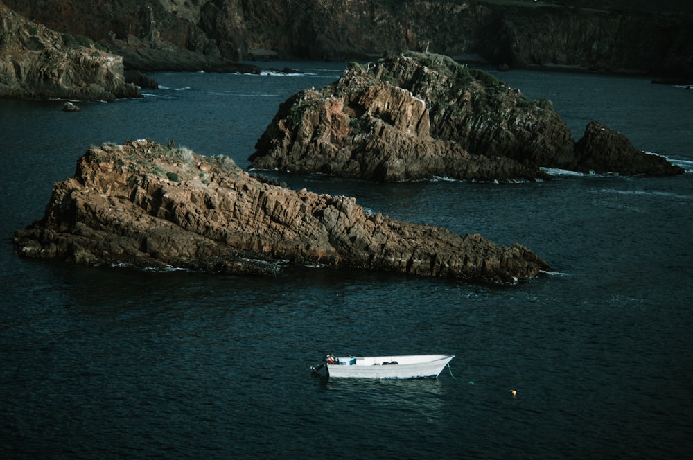 a small boat floating on top of a body of water