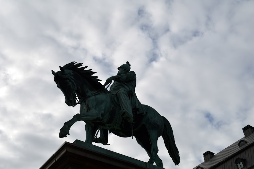 a statue of a man riding on the back of a horse