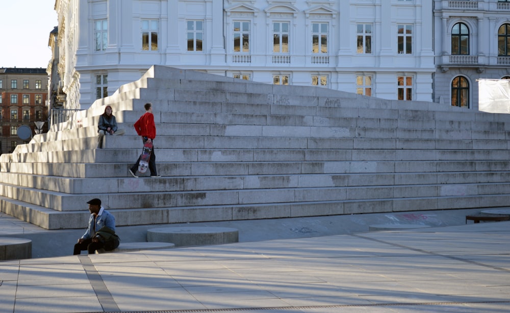a group of people sitting on the steps of a building
