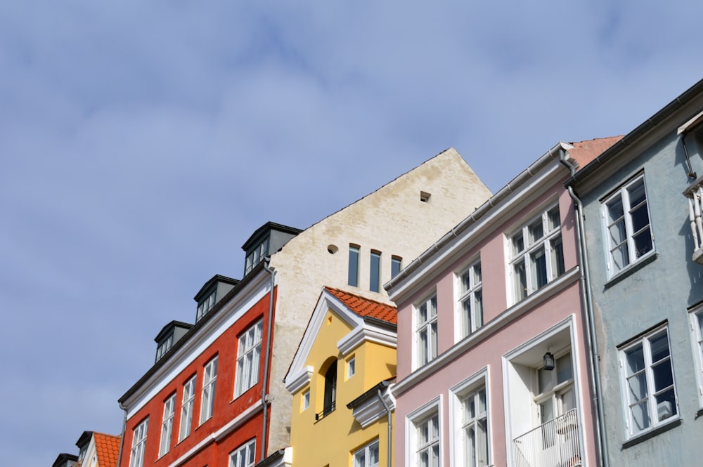 a row of multicolored buildings on a sunny day