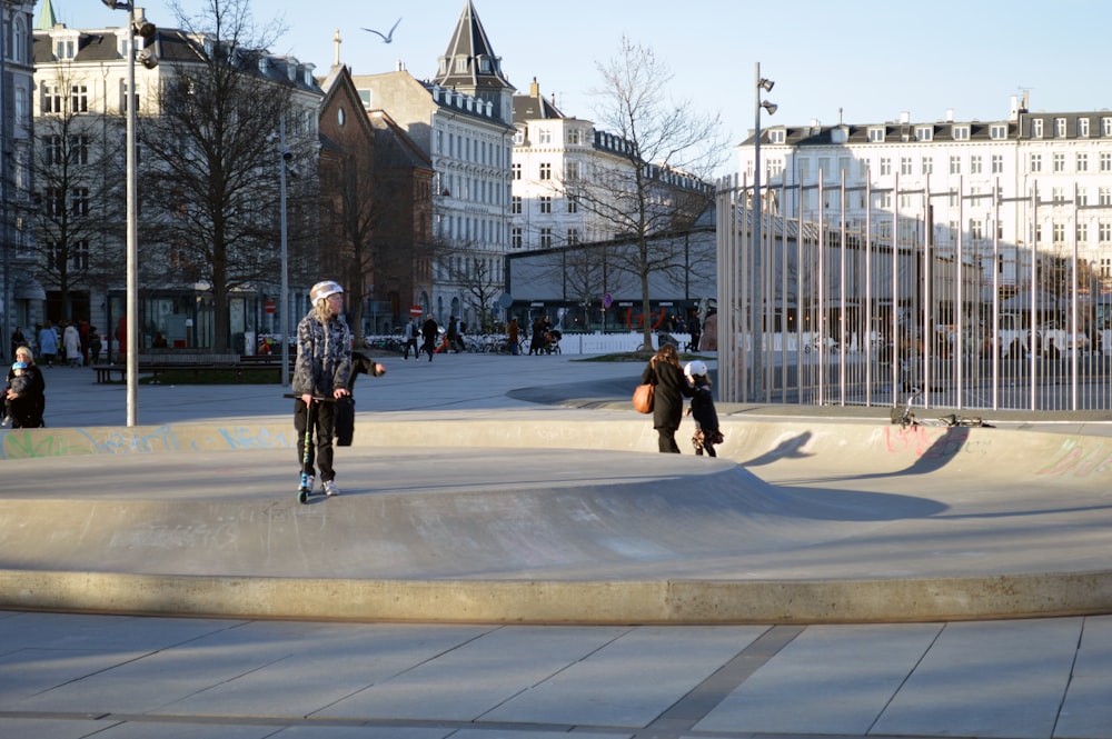 a man riding a skateboard on top of a cement ramp