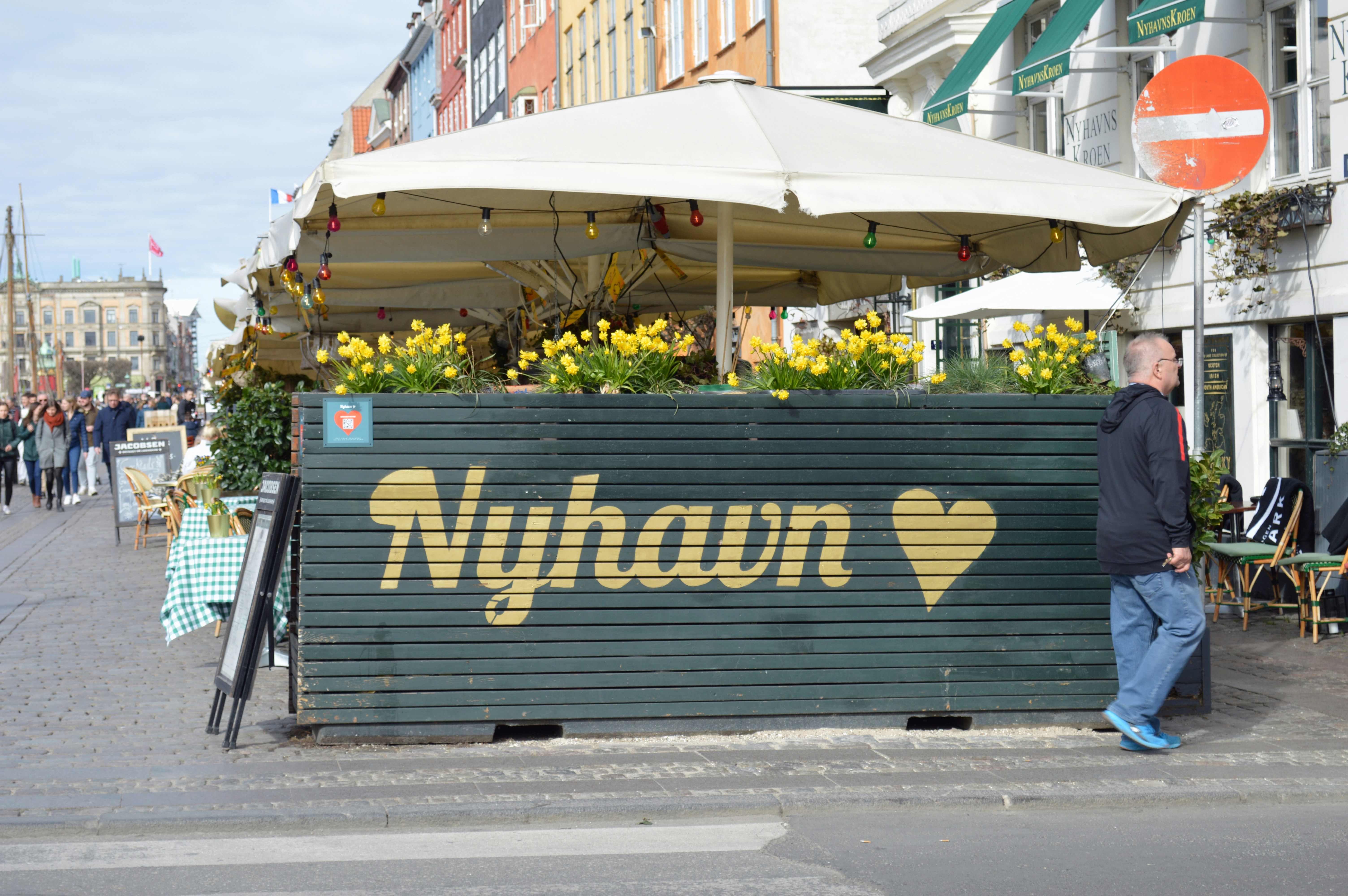 a man standing in front of a sign that says nyhan, Nyhavn