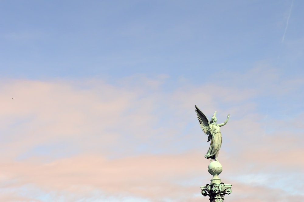 a statue of an angel on top of a building