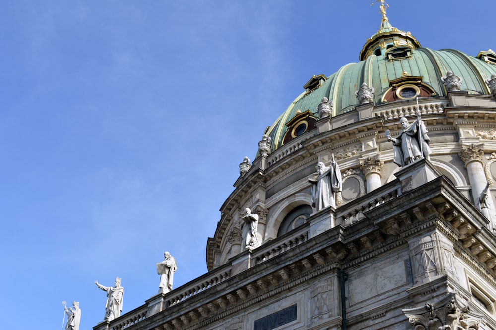 a tall building with statues on top of it